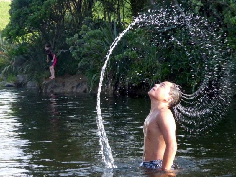 Boy enjoying a Taranaki waterway. Taranaki waterway