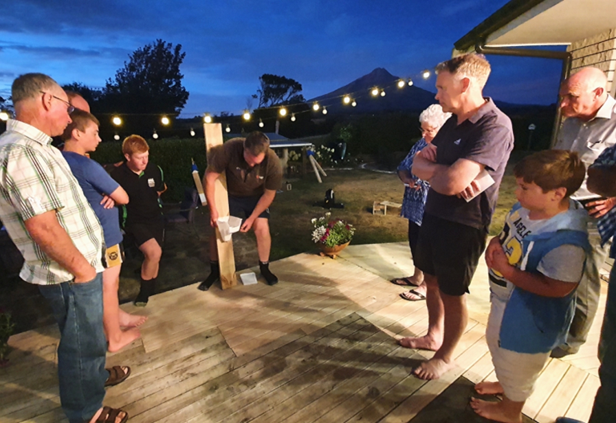 TRC staff demonstrating trap operation at Cram Farm community gathering